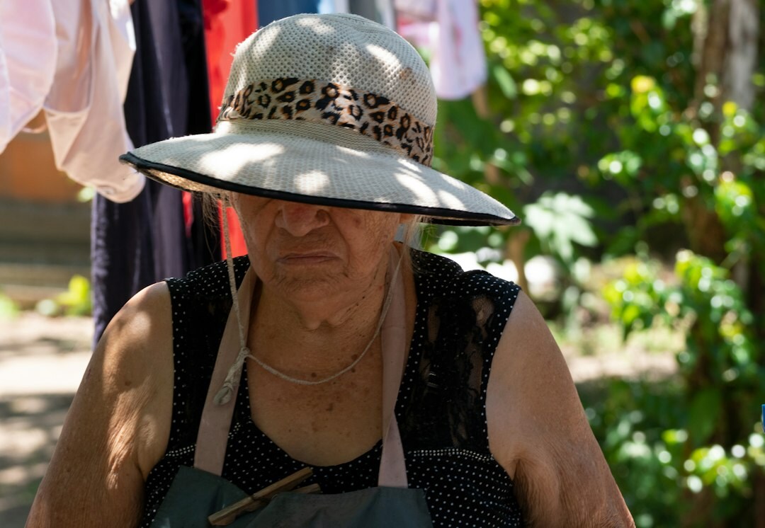 Elderly Japanese woman gardening and smiling in a community garden