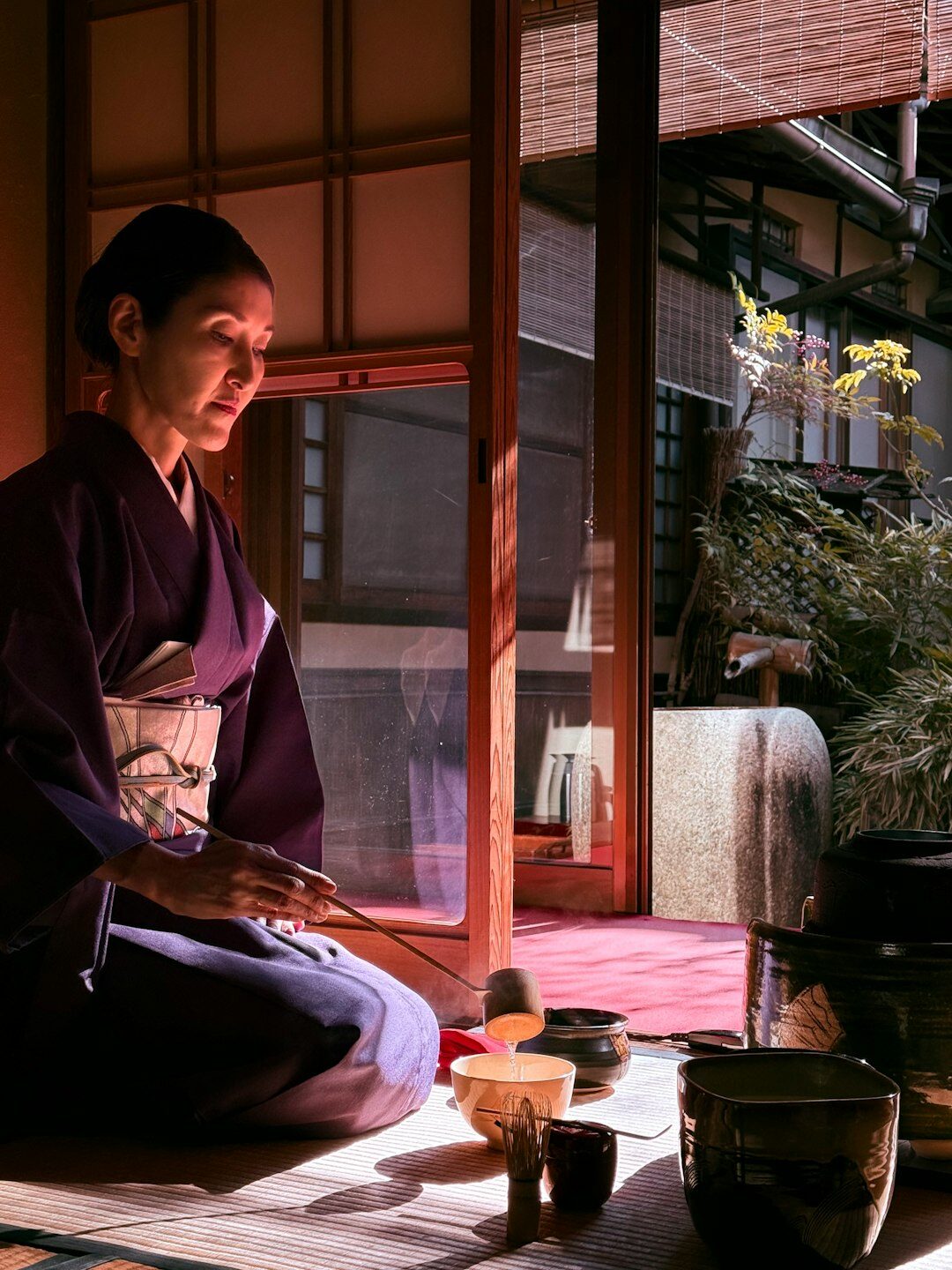 Elderly Japanese women practicing a traditional tea ceremony together