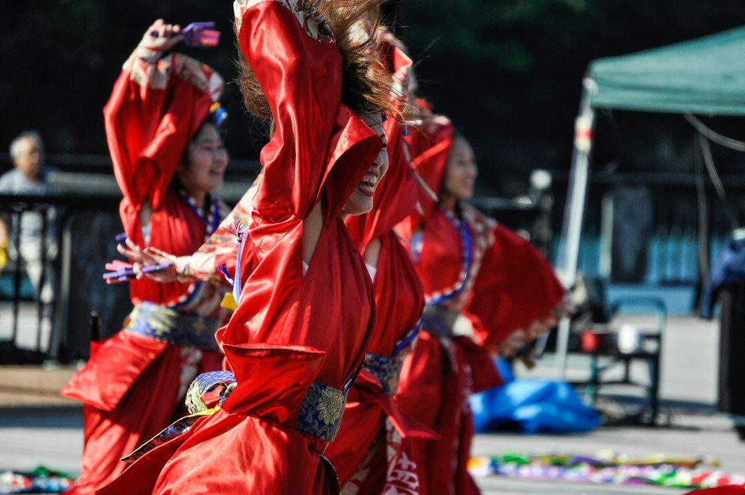Elderly Japanese women dancing a traditional folk dance at a festival