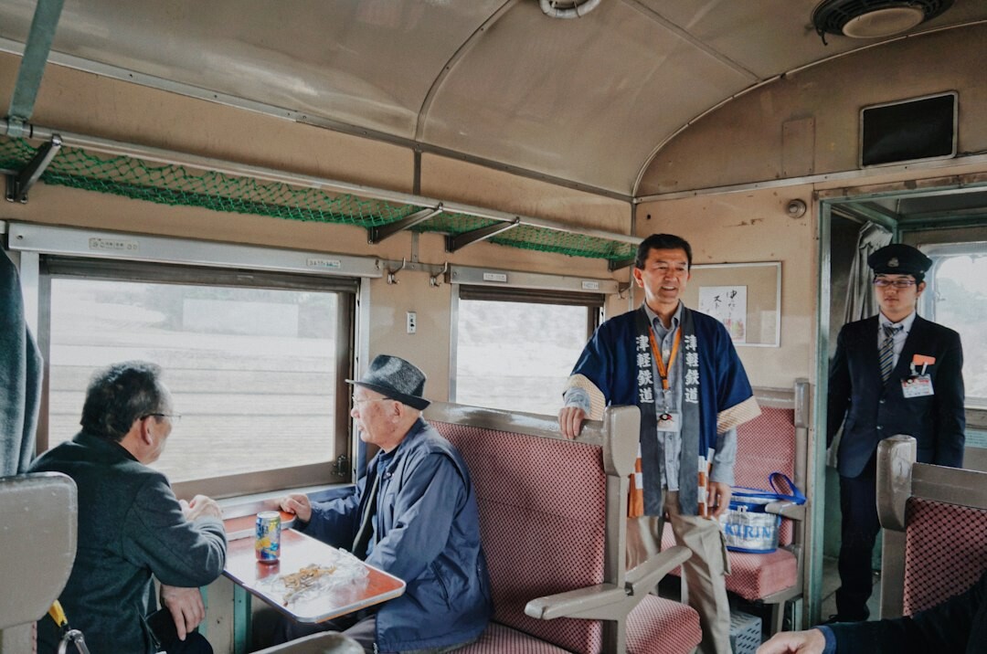 A group of elderly Japanese travelers waving happily from a sightseeing bus trip