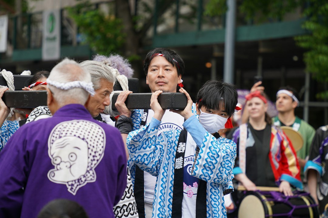 A group of elderly Japanese people singing karaoke together happily